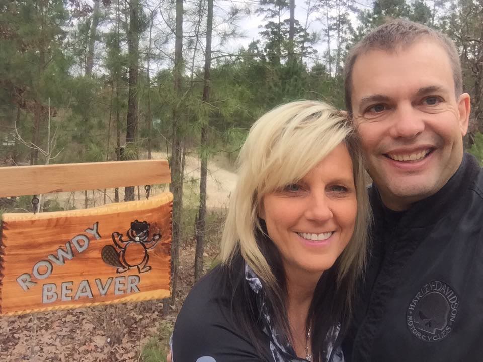 Gary and Michelle Mitchell at the Rowdy Beaver sign